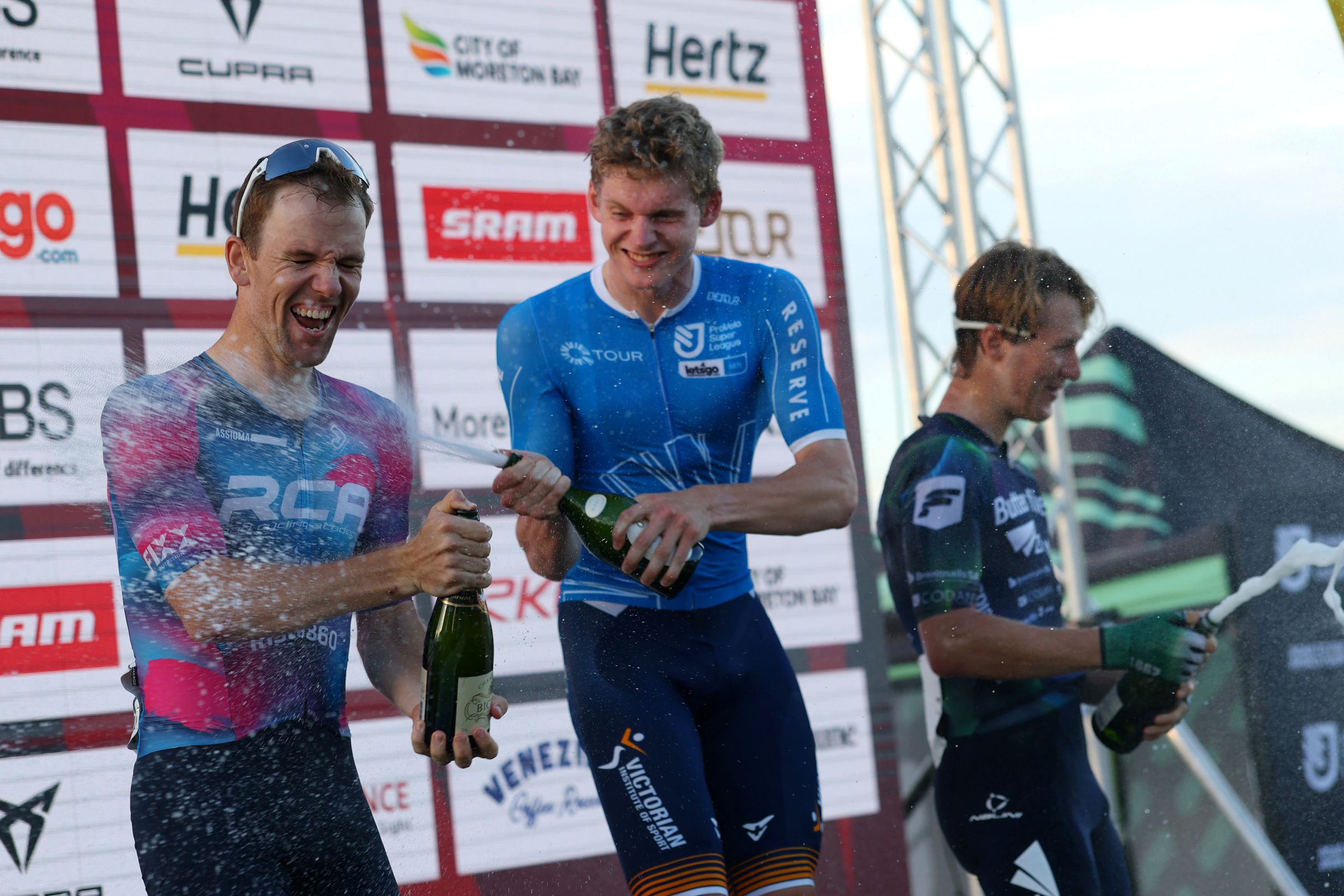 Alistair Forsyth celebrates with a champagne spray after winning Stage 2 of the 2026 Q Tour part of the ProVelo Super League